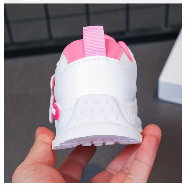 Pink and white toddler sneaker with soft sole and easy-grip design for little feet