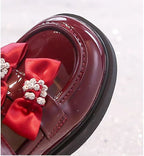 Zapato elegante para niñas con lazo adornado y colores brillantes vista lateral