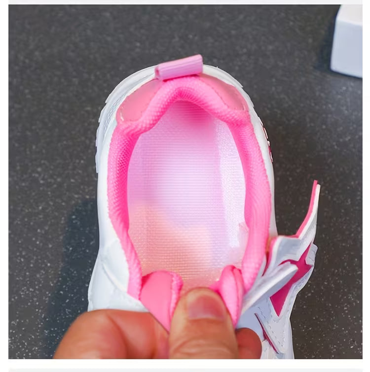 Pink and white kids' sneaker with soft lining and pull tab for easy wear