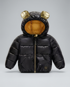 Chaqueta bebé niña y niño invierno impermeable negra con detalles dorados y capucha con orejitas en España