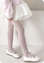 Pink ribbed tights with heart details, white tutu skirt, and Mary Jane shoes for girls