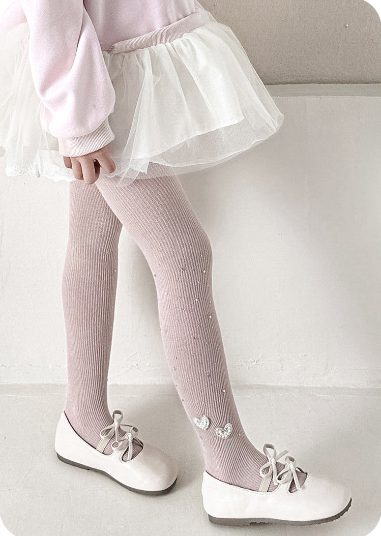 Pink ribbed tights with heart details, white tutu skirt, and Mary Jane shoes for girls