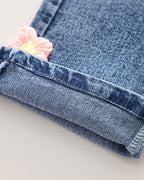 Conjunto niña 3 piezas rosa: suéter, camiseta arcoíris y pantalón vaquero con flores crochet en España