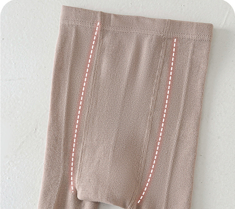 Soft beige kids leggings with ribbed texture and pink dashed seam details, ideal for comfortable everyday wear.