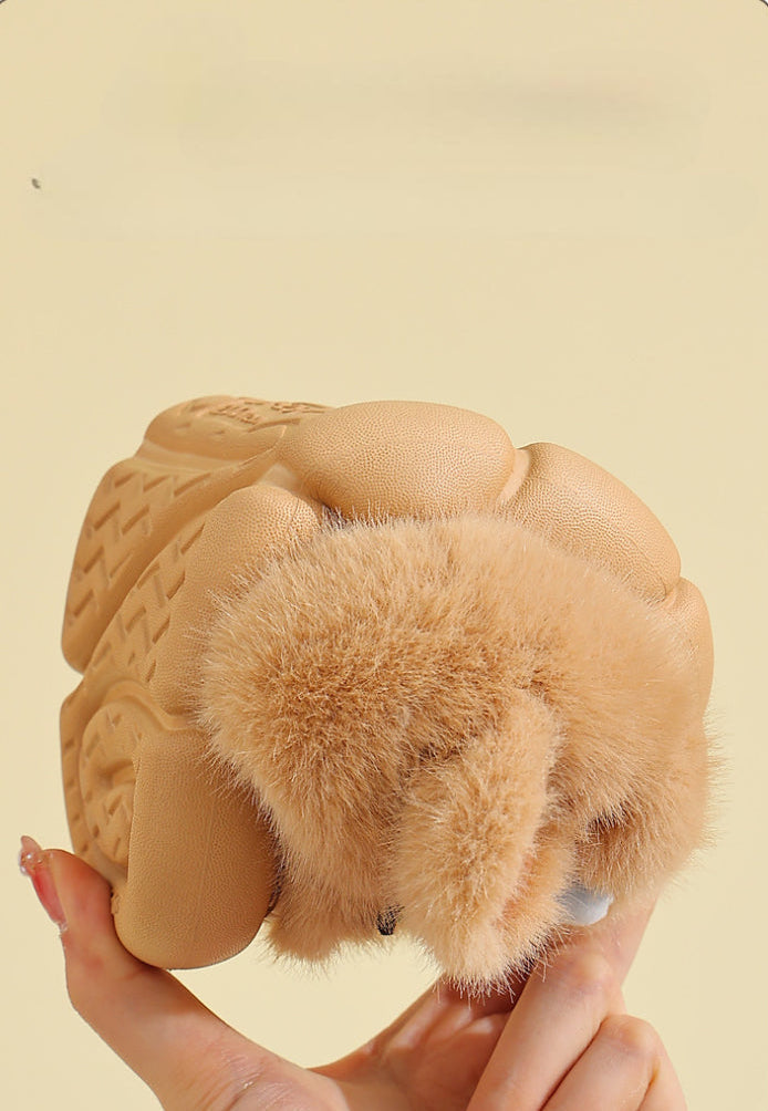 Soft beige baby booties with fluffy fur trim and textured sole for infant comfort and grip