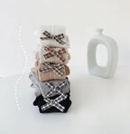 Kids' ribbed tights with plaid bows in white, beige, gray, black — soft, cozy, stylish infant wear