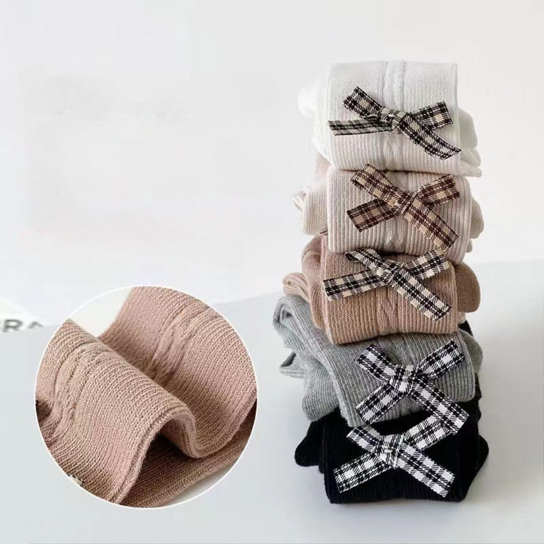 Kids' ribbed tights with plaid bows in white, beige, gray, black — soft, cozy, stylish for children