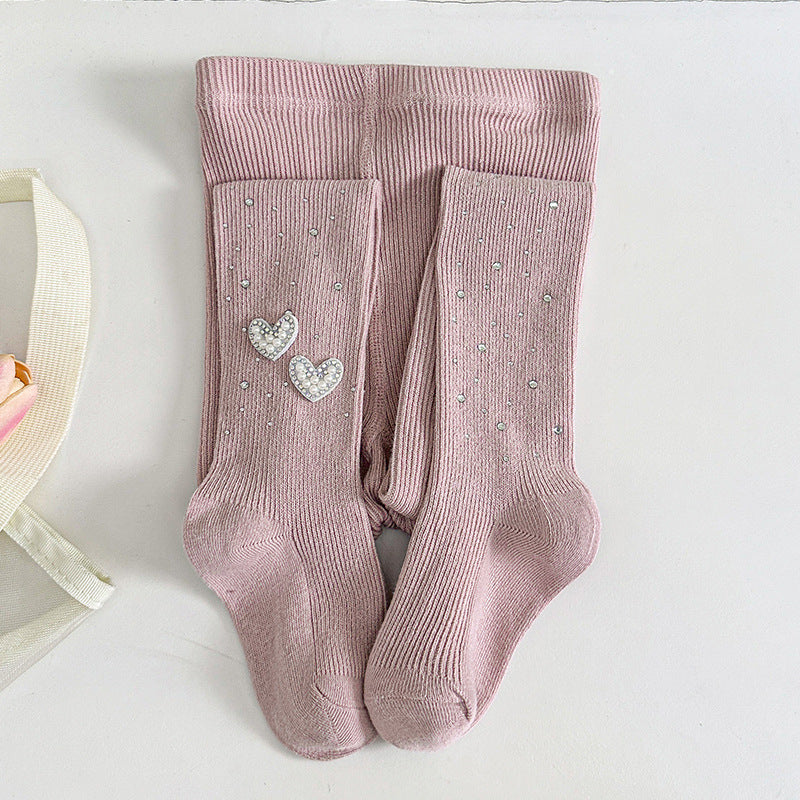 Pink ribbed kids tights with pearl heart embellishments, soft and cozy for little girls