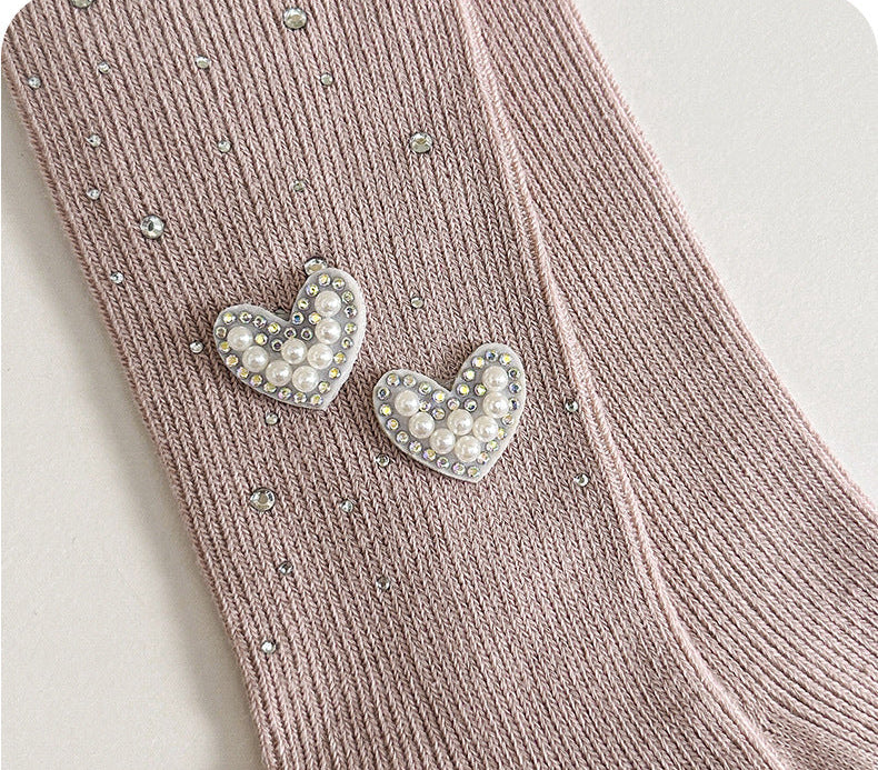 Pink kids' tights with pearl heart embellishments and rhinestone details, soft knit fabric for comfort