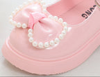 Zapato para niña con diseño de moño adornado con perlas en España