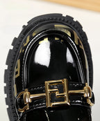 Zapato tipo loafer con diseño moderno y detalle dorado elegante en España
