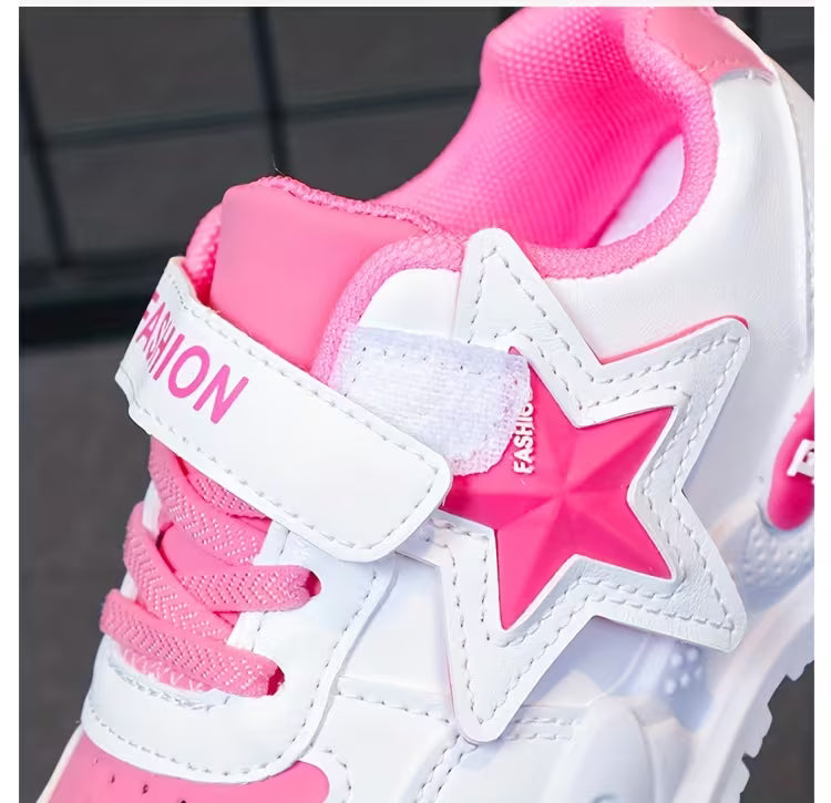 Pink and white kids' sneaker with star design and velcro strap for easy wear